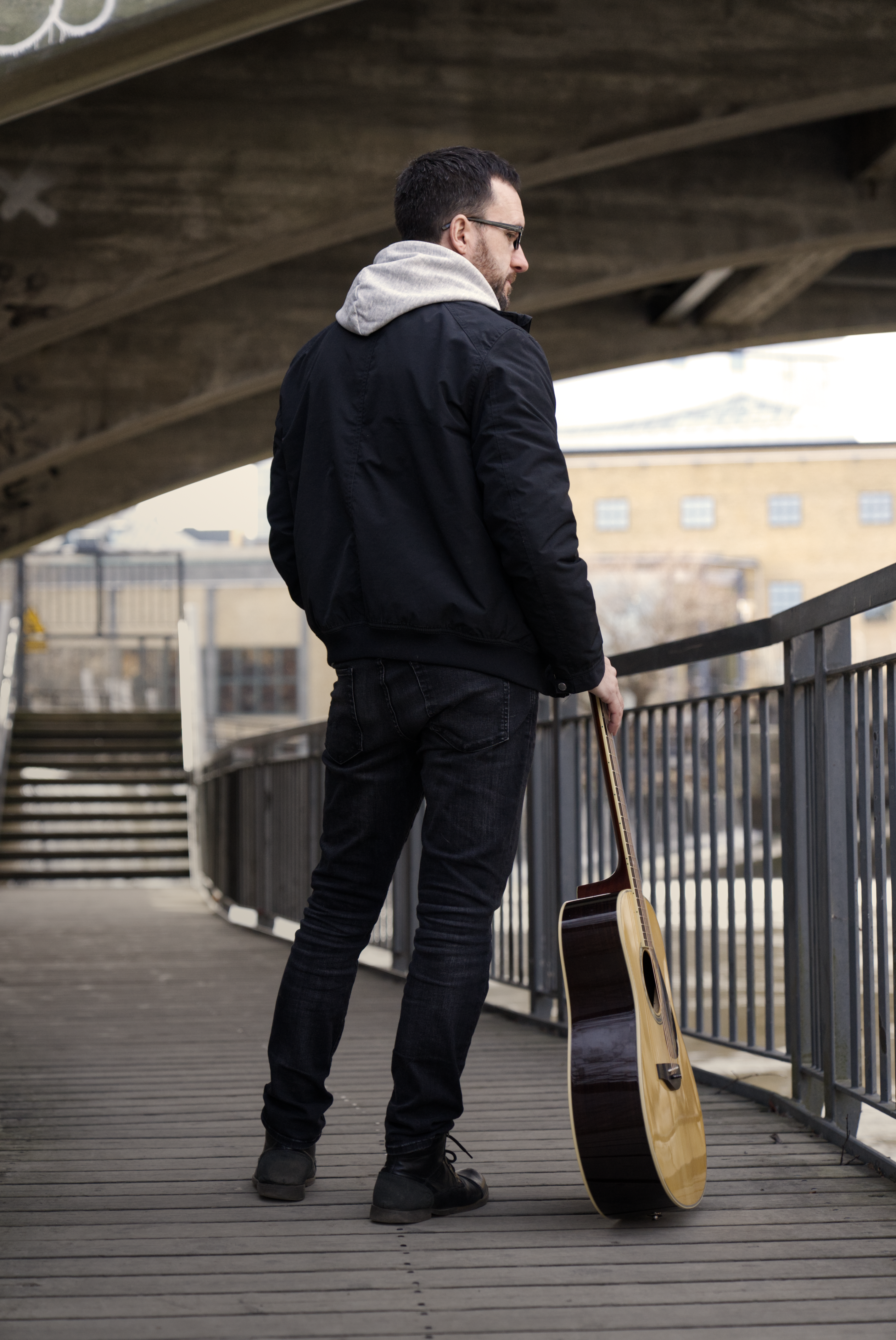 A picture taken of the artist Ola Palmkvist from the back while he stand and looks at the beautiful view 